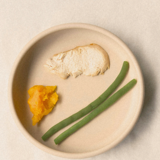 thanksgiving food served to a toddler on silicone plate